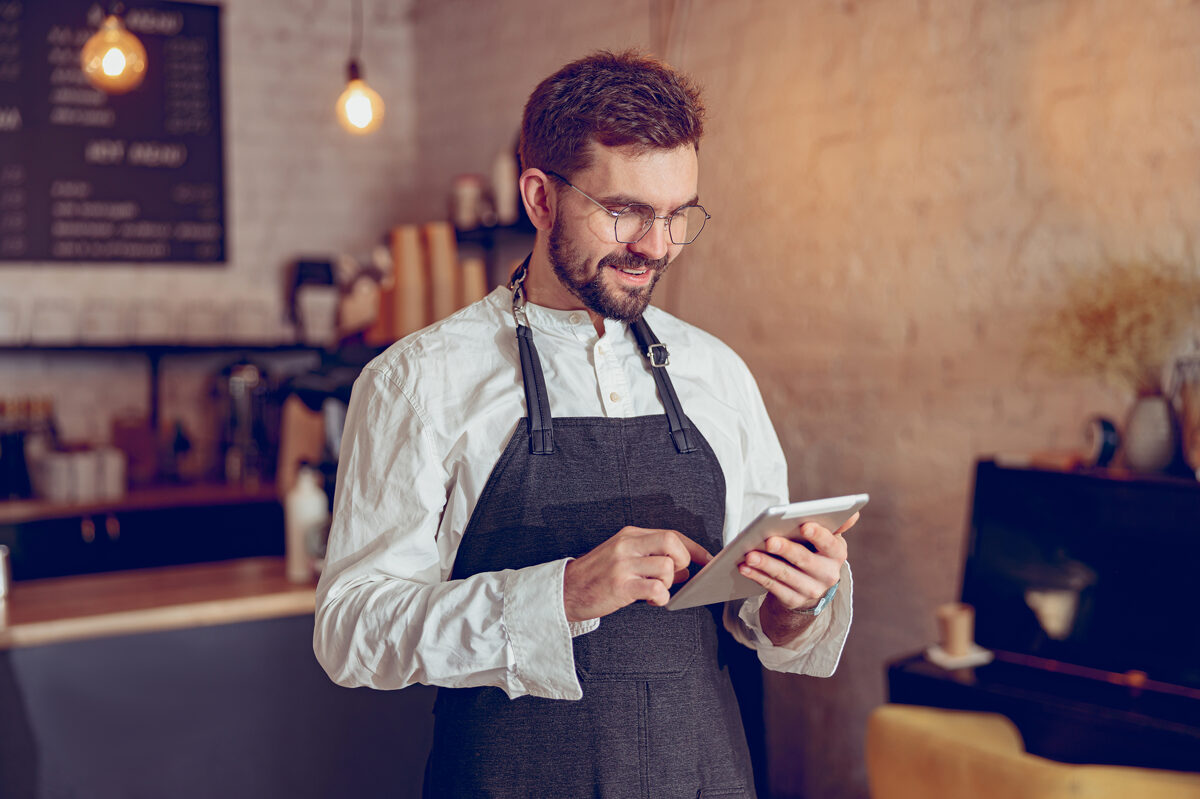 cheerful-male-barista-using-tablet-computer-cafe.jpg
